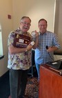 Immediate Past President Tabb Randolph presents with Dan with his Past President's badge and plaque.
